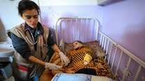 Dr. Jilani tends to a young child at Al Asqa hospital in Gaza.